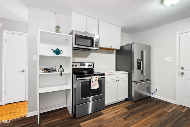 kitchen with white cabinetry, appliances with stainless steel finishes, and dark hardwood / wood-style floors