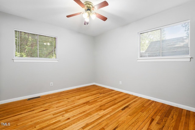 unfurnished room with plenty of natural light, ceiling fan, and light hardwood / wood-style flooring