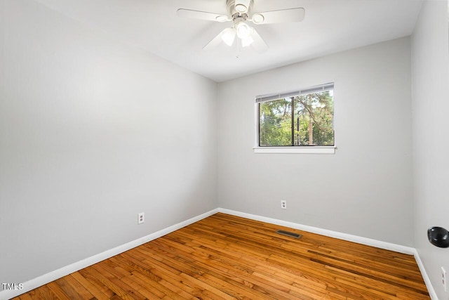 empty room with ceiling fan and wood-type flooring