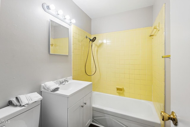 full bathroom featuring vanity, toilet, and tiled shower / bath