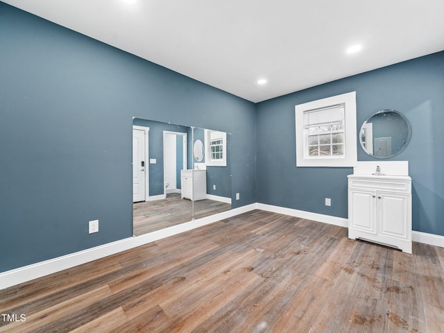 empty room with sink and hardwood / wood-style flooring