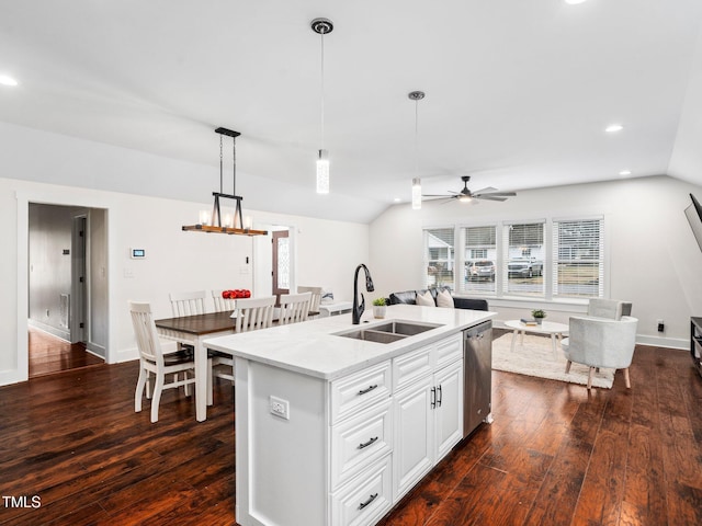 kitchen featuring an island with sink, lofted ceiling, sink, and stainless steel dishwasher