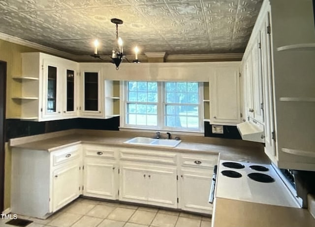 kitchen featuring decorative light fixtures, sink, white cabinets, light tile patterned floors, and an inviting chandelier