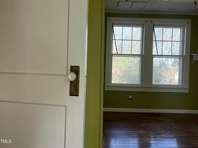 interior space with ornamental molding and wood-type flooring