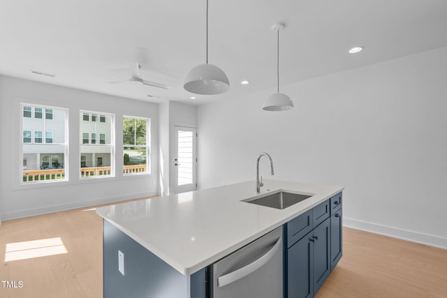 kitchen featuring dishwasher, sink, hanging light fixtures, a kitchen island with sink, and blue cabinetry