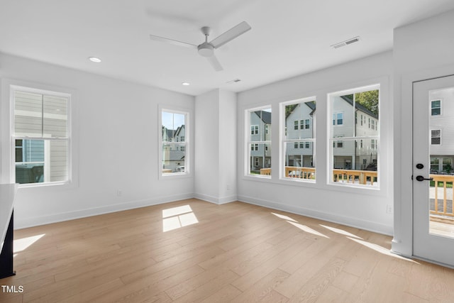 unfurnished room featuring ceiling fan and light hardwood / wood-style floors