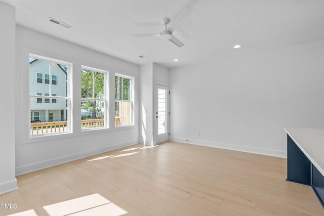 empty room with light hardwood / wood-style flooring and ceiling fan