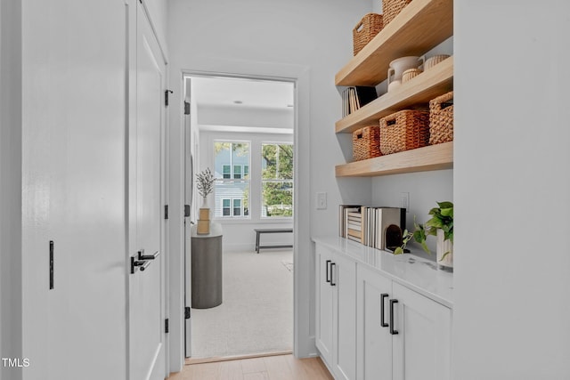 hallway with light hardwood / wood-style floors