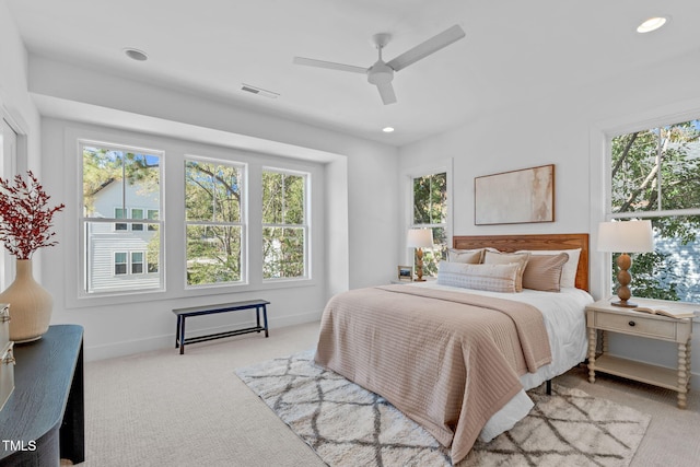 bedroom with ceiling fan and light carpet