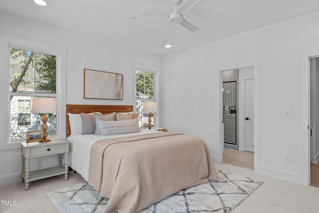 carpeted bedroom featuring multiple windows and ceiling fan