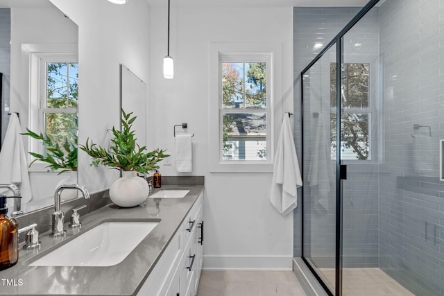 bathroom with vanity and a shower with shower door