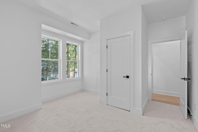 unfurnished bedroom featuring light colored carpet