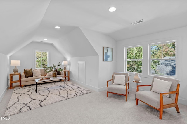 living area featuring lofted ceiling and carpet flooring