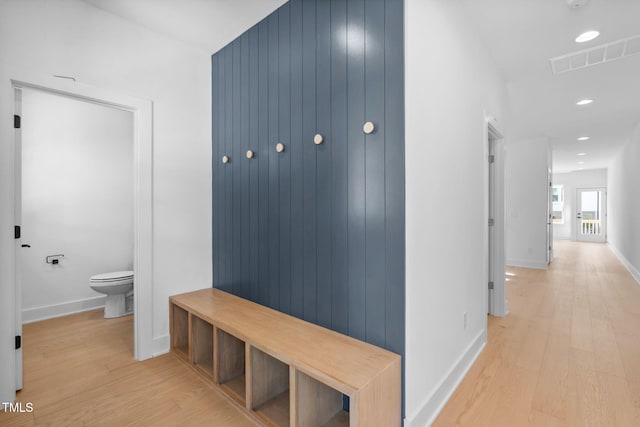 mudroom with light hardwood / wood-style floors