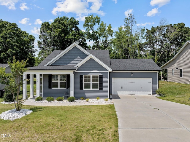 view of front of home with a porch, a garage, and a front lawn