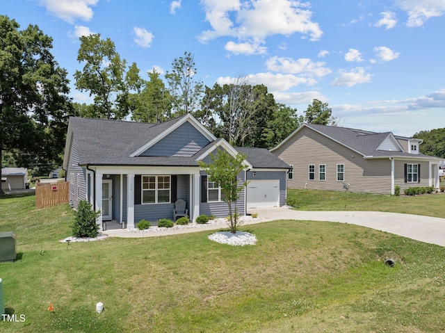 view of front facade featuring a garage, covered porch, and a front lawn