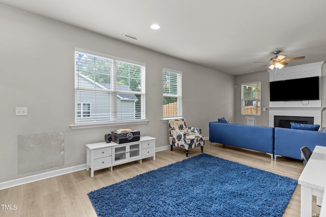 living room featuring ceiling fan and light wood-type flooring