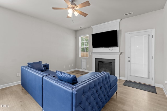 living room with hardwood / wood-style floors and ceiling fan