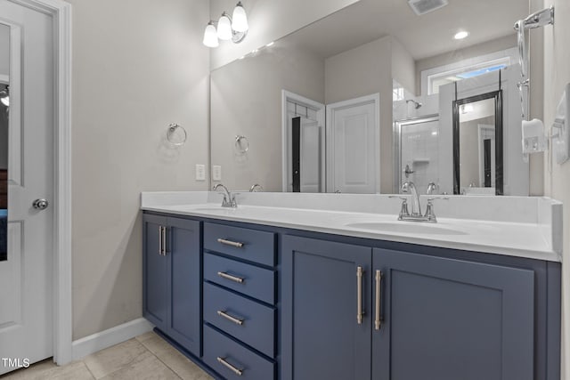 bathroom with tile patterned floors, vanity, and an enclosed shower