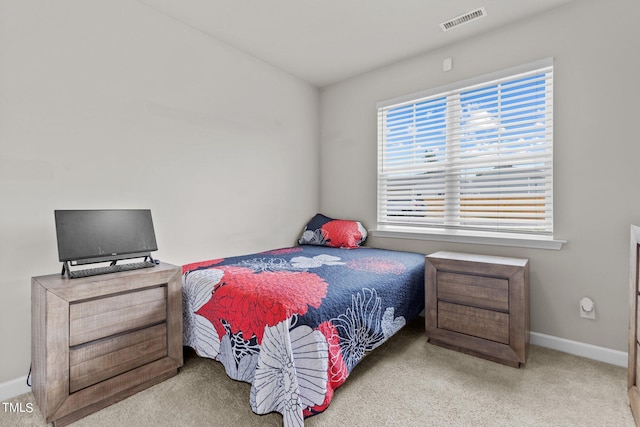 bedroom with light colored carpet