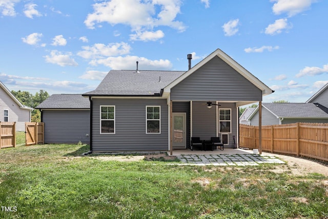 rear view of house featuring a patio, a yard, and ceiling fan