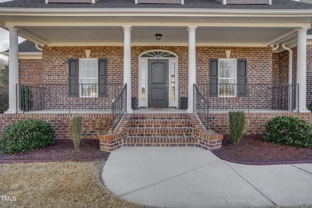 view of exterior entry with a porch