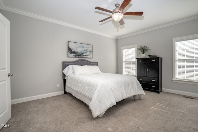 carpeted bedroom with crown molding and ceiling fan