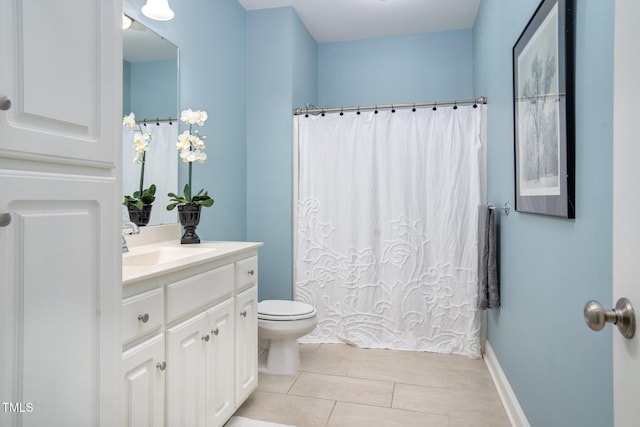 bathroom featuring vanity, tile patterned floors, and toilet