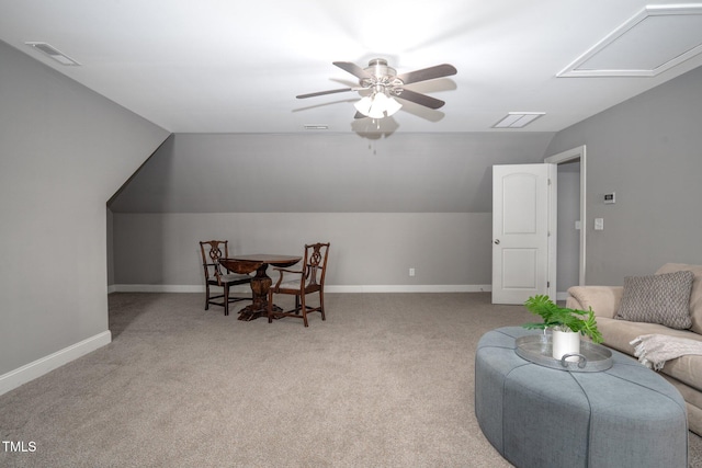 interior space with vaulted ceiling, light colored carpet, and ceiling fan