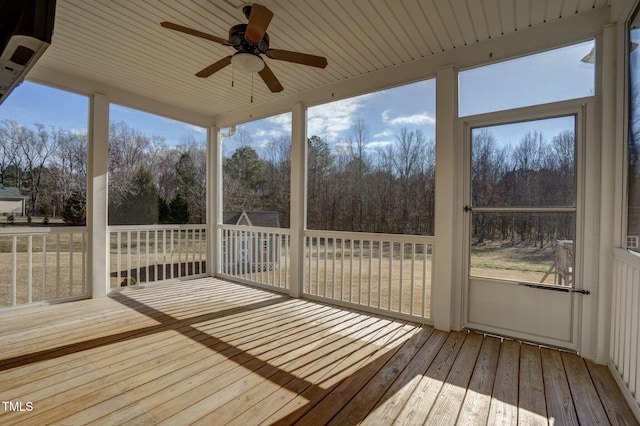 unfurnished sunroom featuring ceiling fan