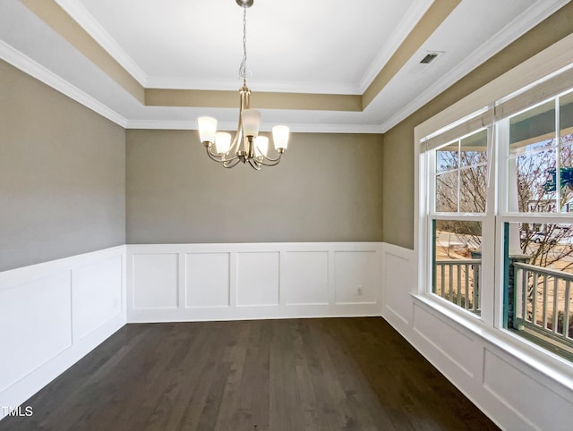 empty room featuring an inviting chandelier, crown molding, dark hardwood / wood-style flooring, and a raised ceiling