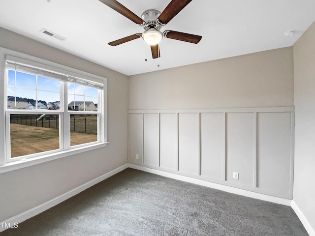 spare room featuring carpet floors and ceiling fan