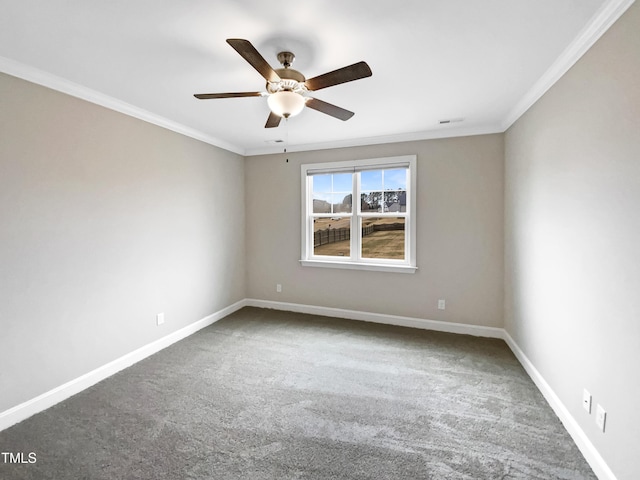 carpeted spare room with ceiling fan and ornamental molding