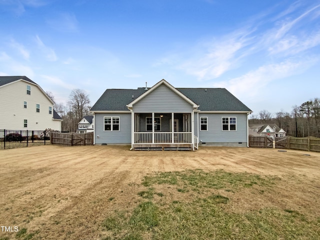 back of house featuring a sunroom and a lawn