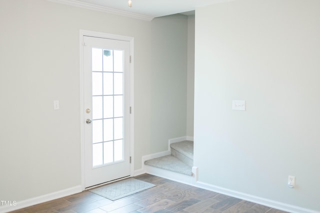 doorway to outside featuring ornamental molding