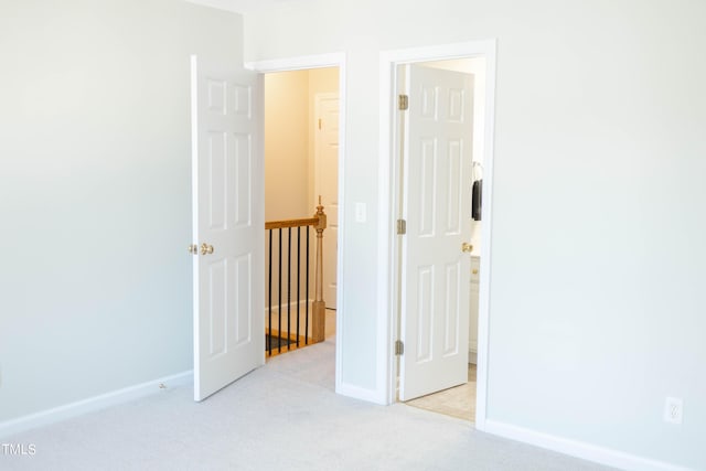 unfurnished room featuring light colored carpet