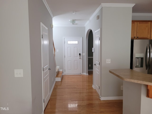 corridor featuring crown molding and light hardwood / wood-style floors