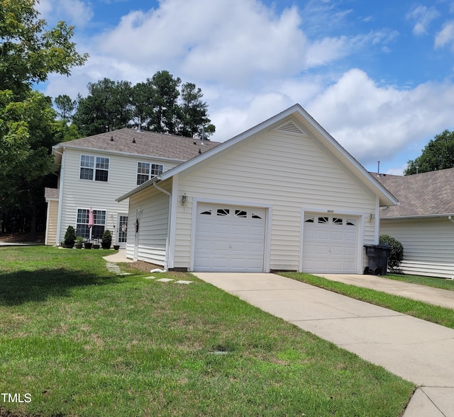 view of front of house featuring a garage and a front lawn