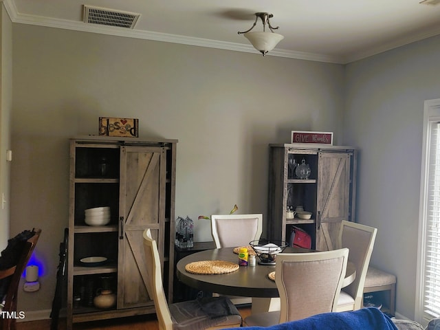 dining area featuring crown molding and a barn door