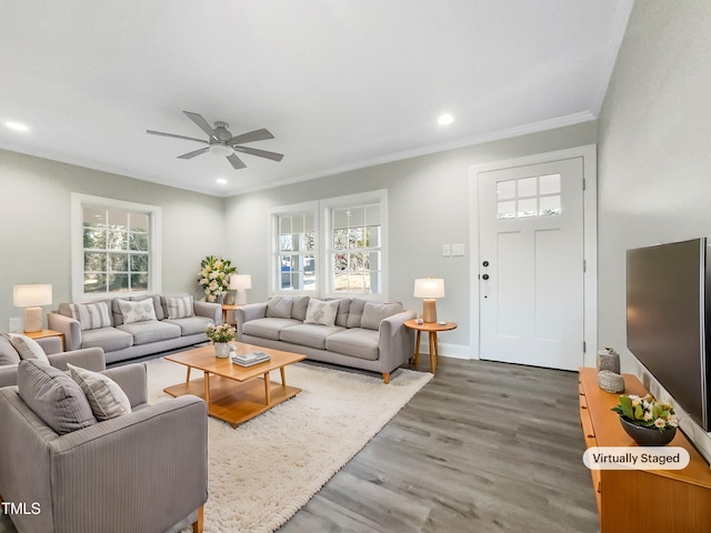 living room with ceiling fan, ornamental molding, and dark hardwood / wood-style floors