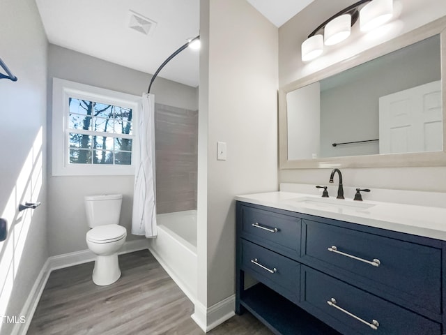 full bathroom featuring vanity, wood-type flooring, toilet, and shower / bath combo with shower curtain