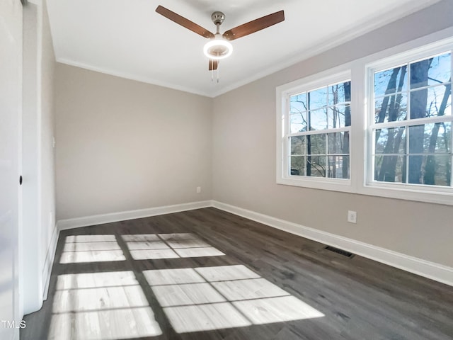 empty room with crown molding, ceiling fan, and dark wood-type flooring