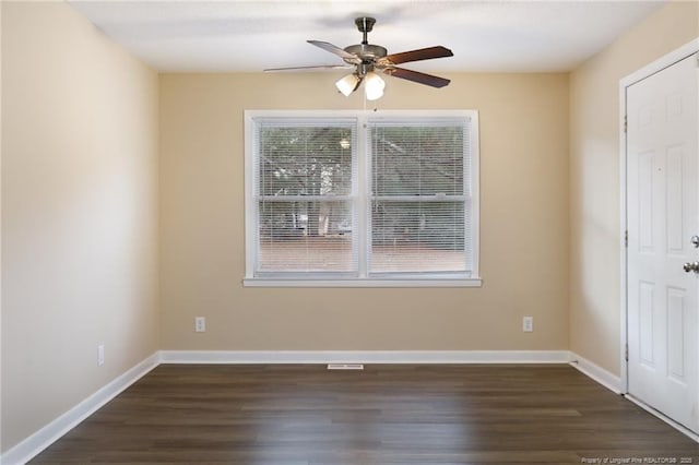 empty room with dark wood-type flooring and ceiling fan