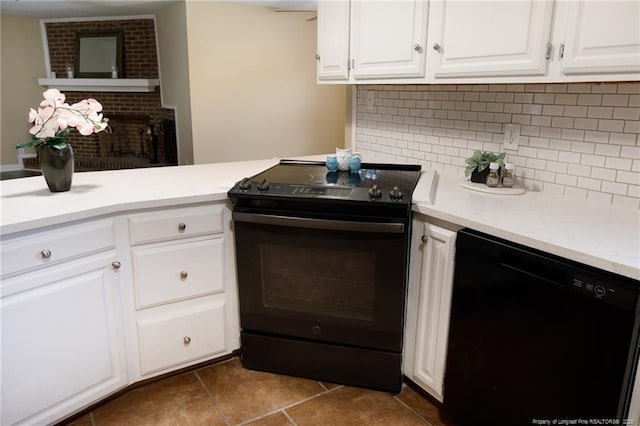 kitchen featuring white cabinetry, dark tile patterned floors, tasteful backsplash, and black appliances