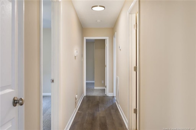 corridor featuring dark wood-type flooring