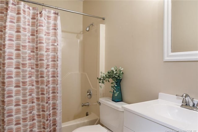 full bathroom featuring vanity, shower / bath combo with shower curtain, and toilet