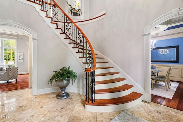 stairs featuring a chandelier and a high ceiling