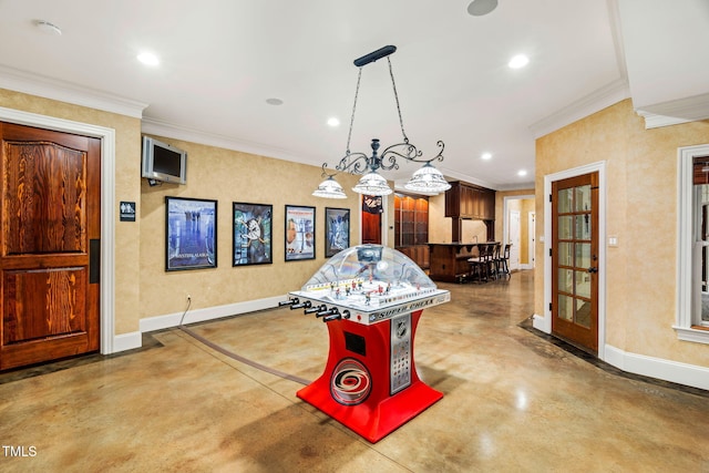 rec room with ornamental molding and concrete floors