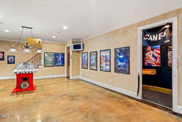 recreation room with concrete flooring and crown molding