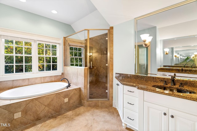 bathroom featuring vanity, vaulted ceiling, tile patterned floors, and independent shower and bath